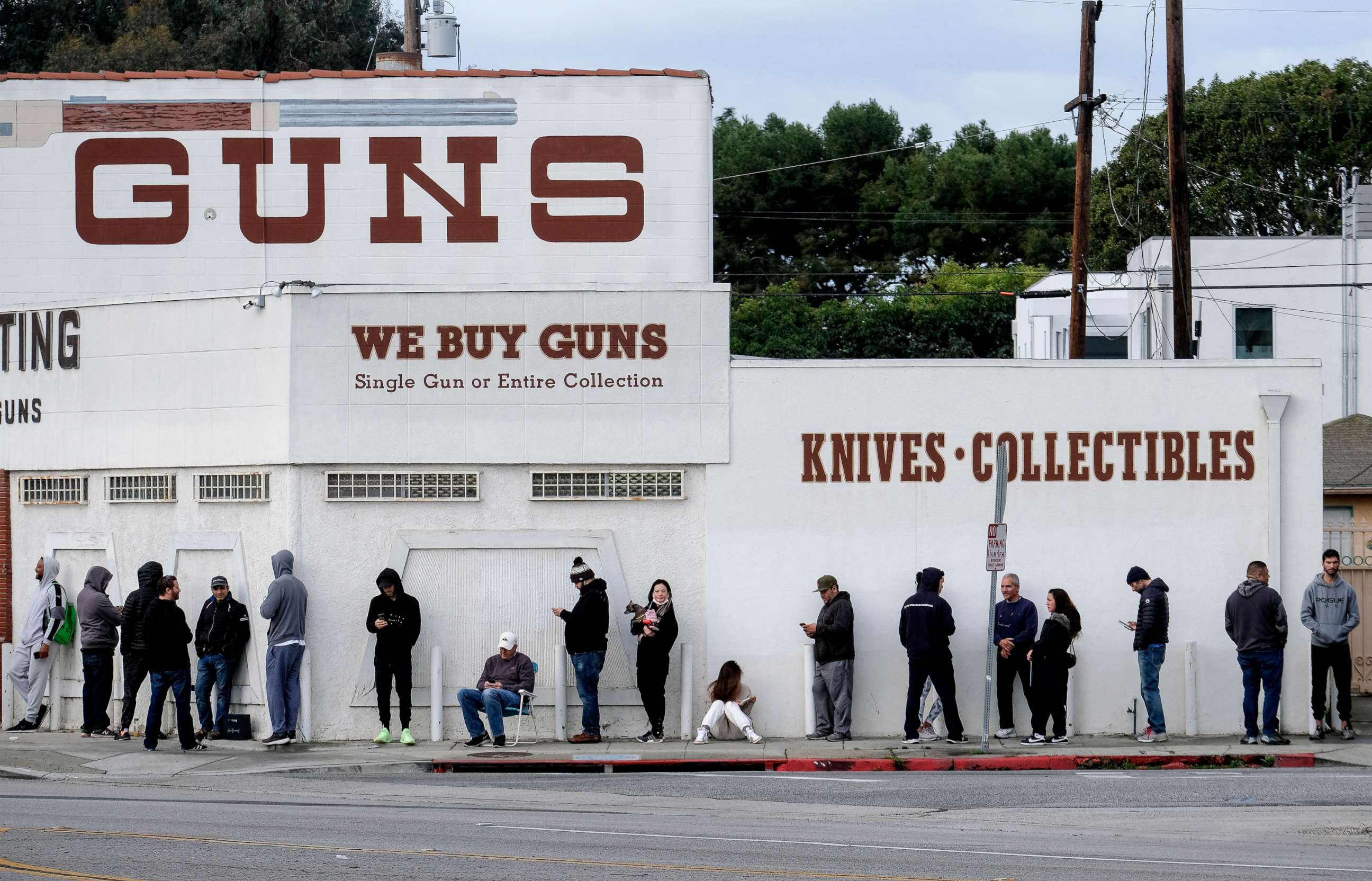 PHOTO: People wait in a line to enter a gun store in Culver City, Calif., March 15, 2020.