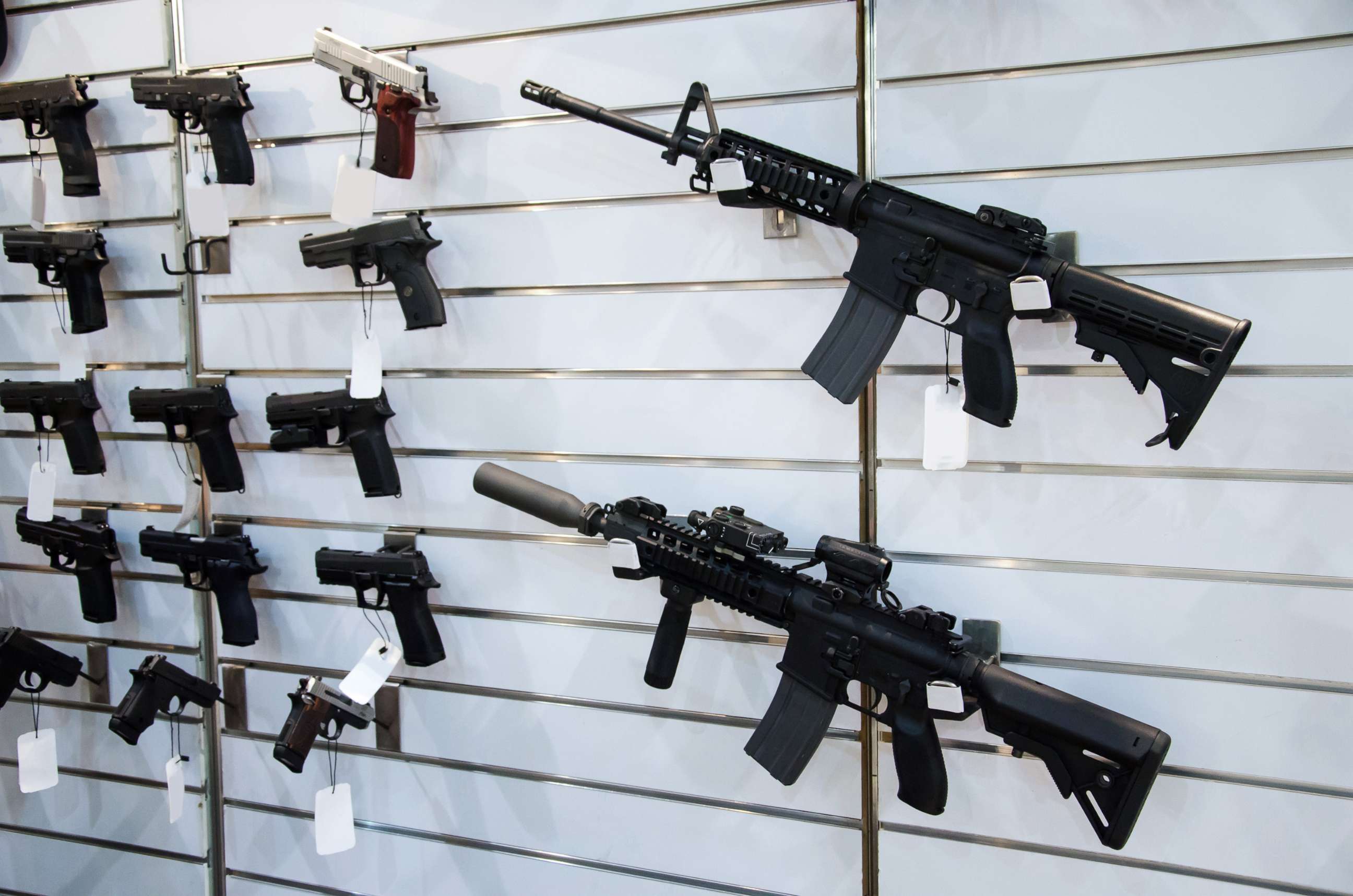 PHOTO: Gun wall rack with rifles and pistol.