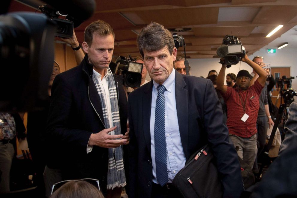 PHOTO: Gun City store owner David Tipple, center, leaves a press conference at the Piano Event Centre in Christchurch, March 18th, 2019.