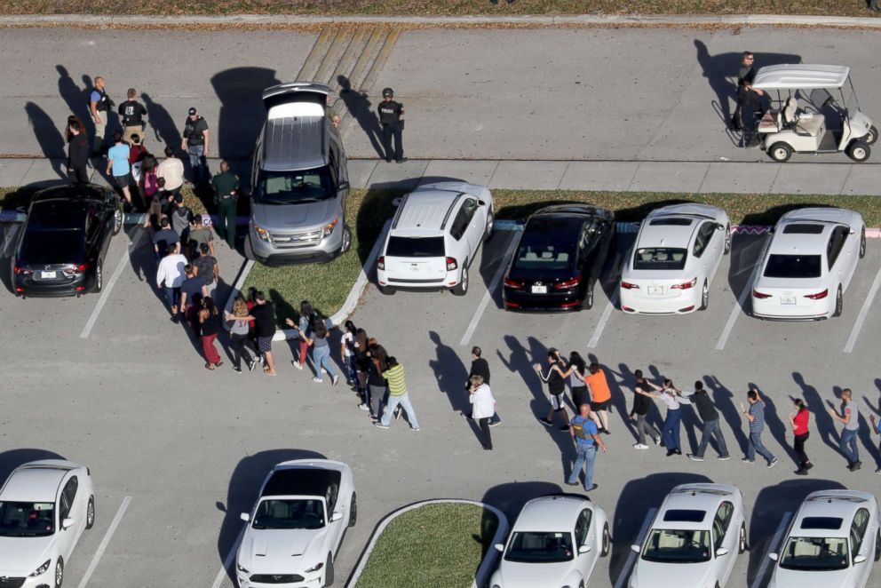 PHOTO: Students are evacuated by police out of Stoneman Douglas High School in Parkland, Fla., after a shooting on Feb. 14, 2018.
