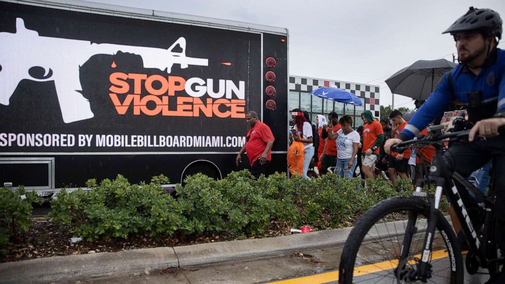 PHOTO: People walk together during a Gun Violence Peace March, June 16, 2021, in Miami.