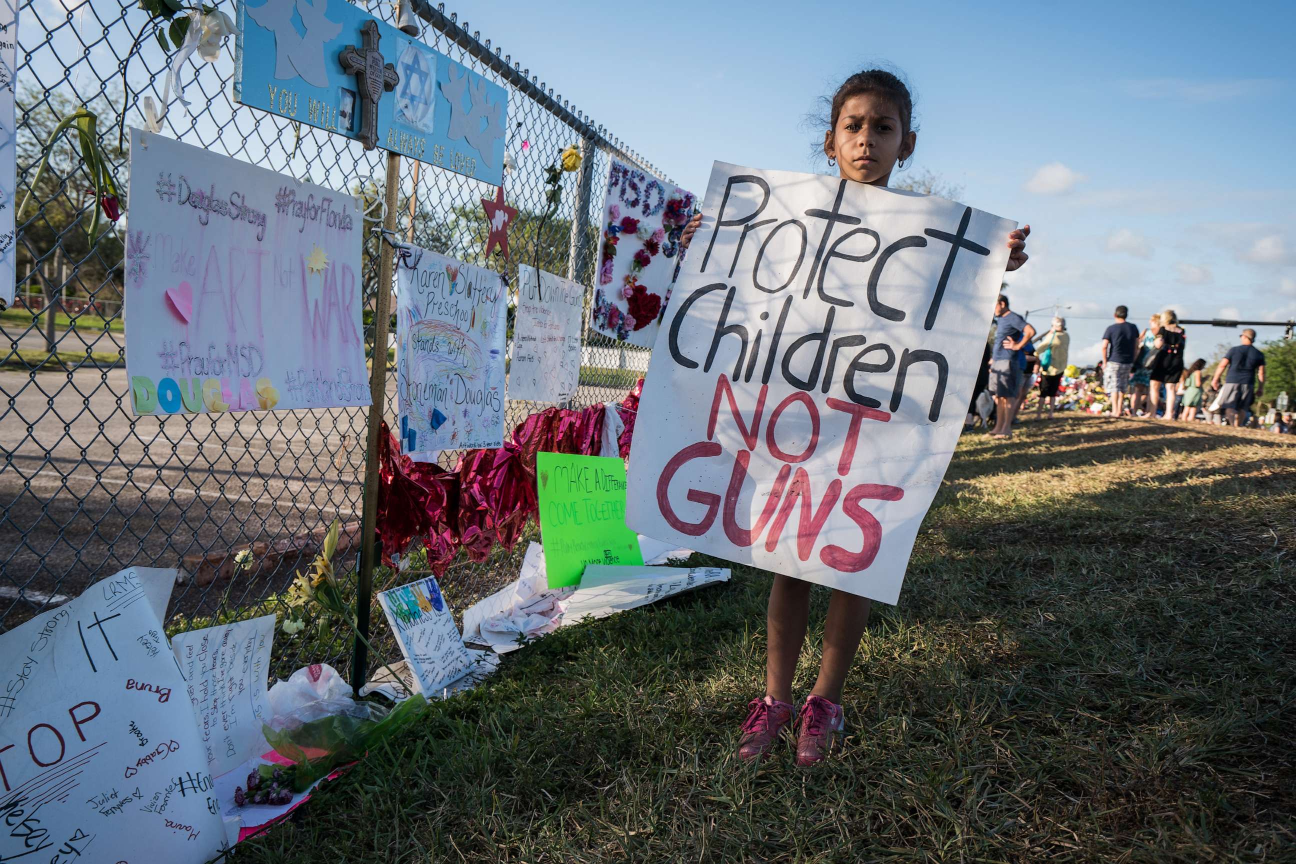 PHOTO: A young school child holds a sign 'Protect Children NOT Guns' at Stoneman Douglas High School, in Parkland, Fla., Feb. 25, 2018.