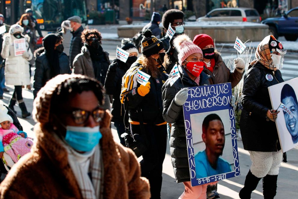 PHOTO: People holding placards walk during an anti gun violence march on the Magnificent Mile in Chicago, Dec. 31, 2020.