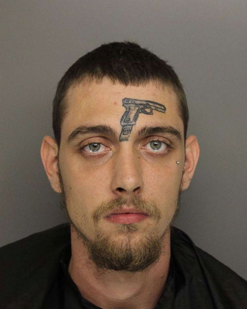 A man with a tattoo of a gun on his face was arrested and charged with illegally possessing a gun.