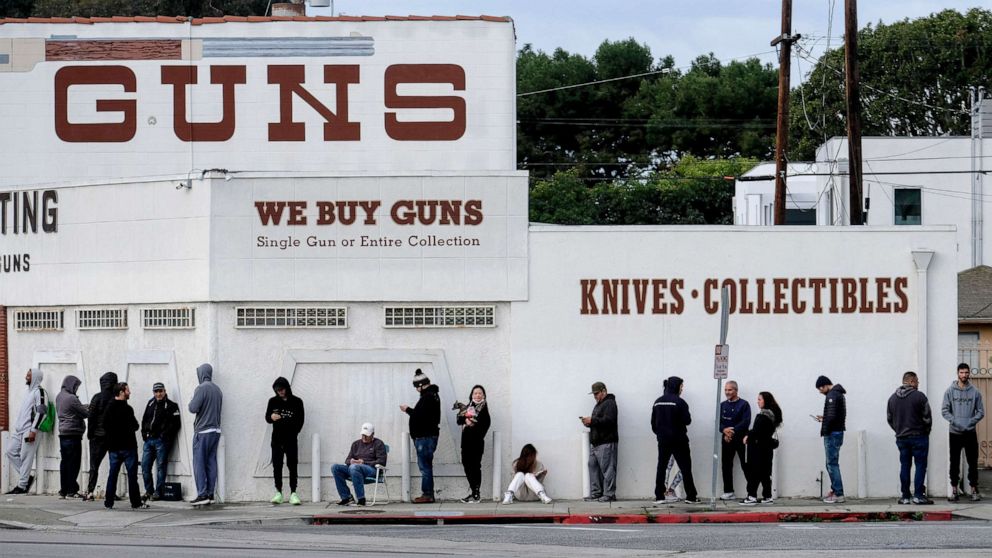 PHOTO: People wait in a line to enter a gun store in Culver City, Calif., March 15, 2020.