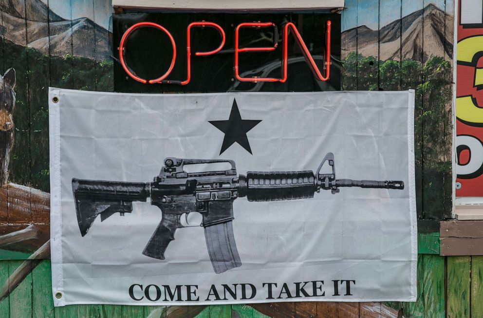 PHOTO: A banner featuring an AR-15 automatic weapon hangs outside a store, on May 11, 2018, in Cherokee, N.C., near the Great Smoky Mountains National Park which straddles the Tennessee and North Carolina borders.