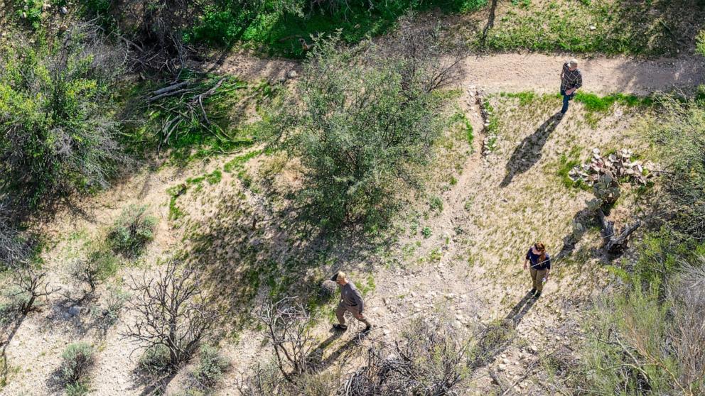 PHOTO: FBI investigator surveil an area around Nancy Guthrie's residence, February 11, 2026 in Tucson, Arizona. 