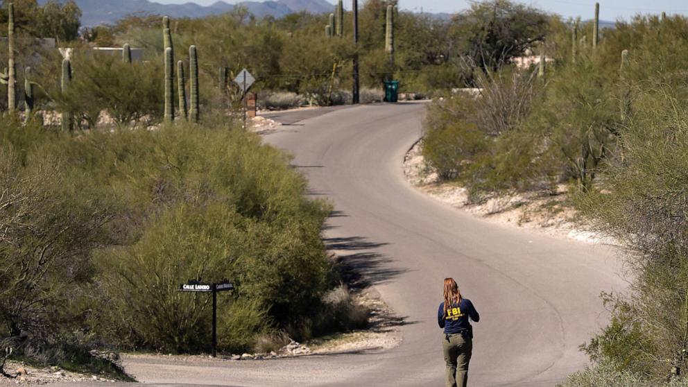 PHOTO: An FBI investigator searches the area near Nancy Guthrie's home in the Catalina Foothills in Tucson, Arizona, February 11, 2026.  