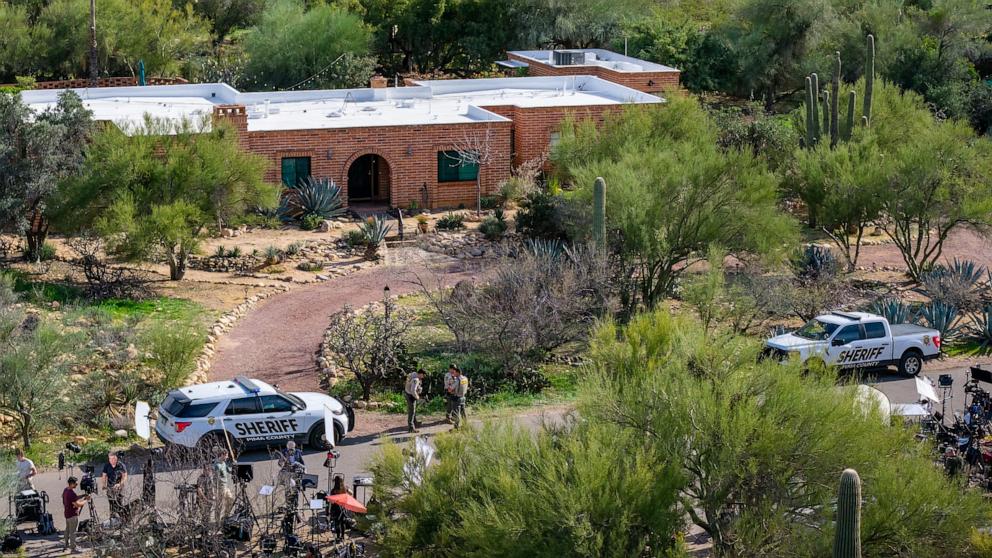 PHOTO: In an aerial view, law enforcement and news broadcasters are stationed outside of Nancy Guthrie's residence on February 10, 2026 in Tucson, Arizona.