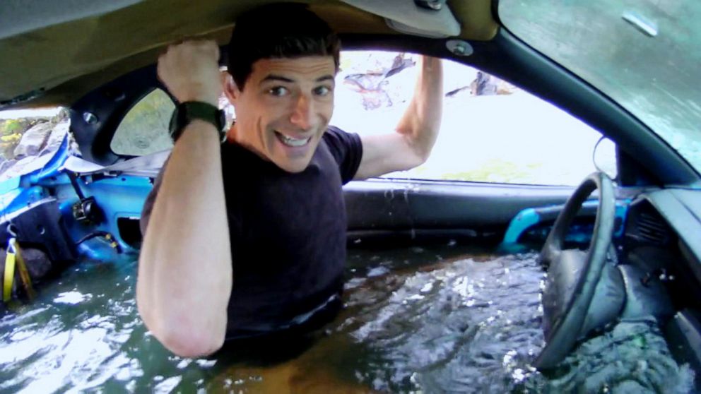 PHOTO: ABC News' chief national correspondent Matt Gutman demonstrates how to safely escape a car during a flash flood.