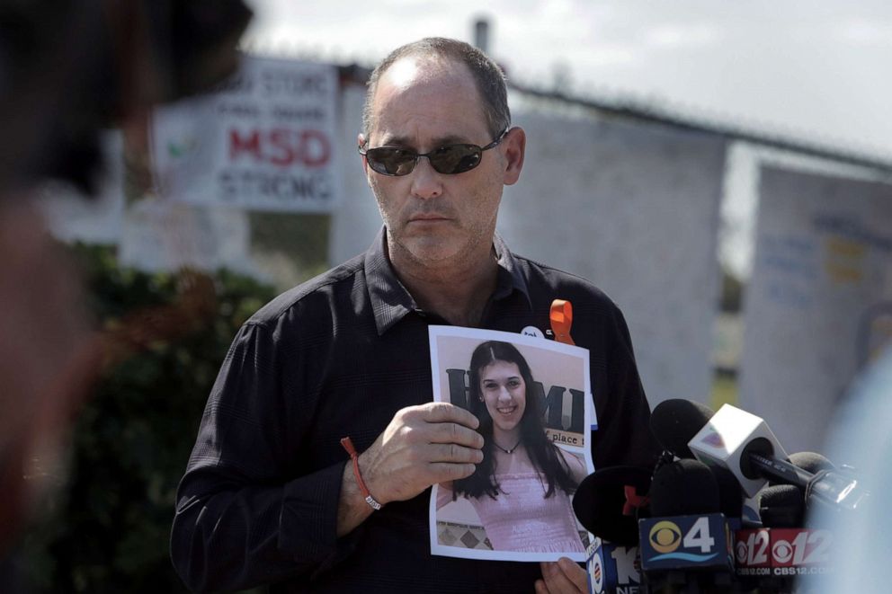PHOTO: Fred Guttenberg holds a picture of his slain daughter, Jaime, as he listens to questions from the media in front Stoneman Douglas high school on March 5, 2018 in Parkland, Fla.