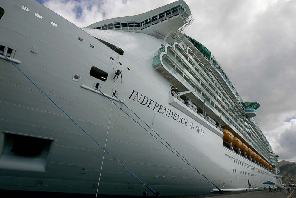 PHOTO: A worker cleans the side of the Independence of the Seas cruise ship on its first trip in the Canary Islands of Tenerife on May 10, 2008. The ship belongs to the Royal Caribbean Cruise Lines. 