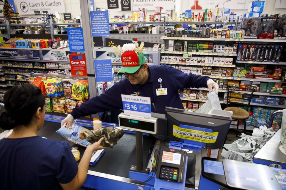 PHOTO: An employee scans items for a customer at a Walmart Stores Inc. location in Burbank, California, U.S., on Thursday, November 16, 2017.