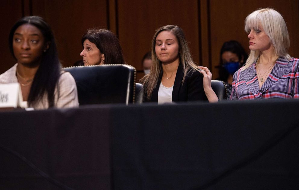 PHOTO: In this Sept. 15, 2021, file photo, U.S. gymnasts Jessica Howard (at right) and Kaylee Lorincz watch as U.S. Olympic gymnast Simone Biles testifies during a Senate Judiciary committee hearing on Capitol Hill, in Washington, D.C.