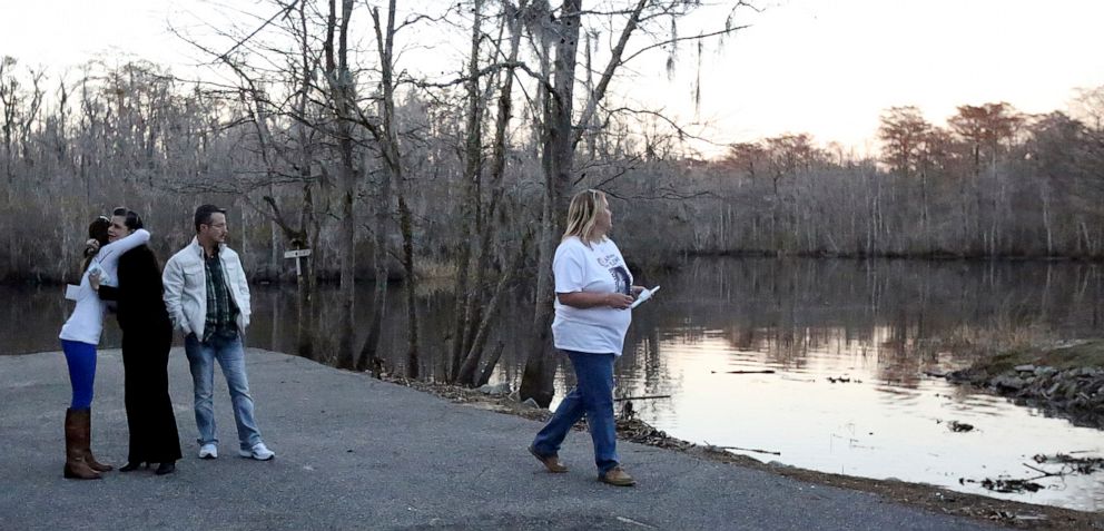 PHOTO: Debbi Elvis, left, embraces a friend as Terry Elvis looks toward the river during a prayer vigil for Heather Elvis at Peachtree Landing in Myrtle Beach, S.C., Feb. 24, 2014.