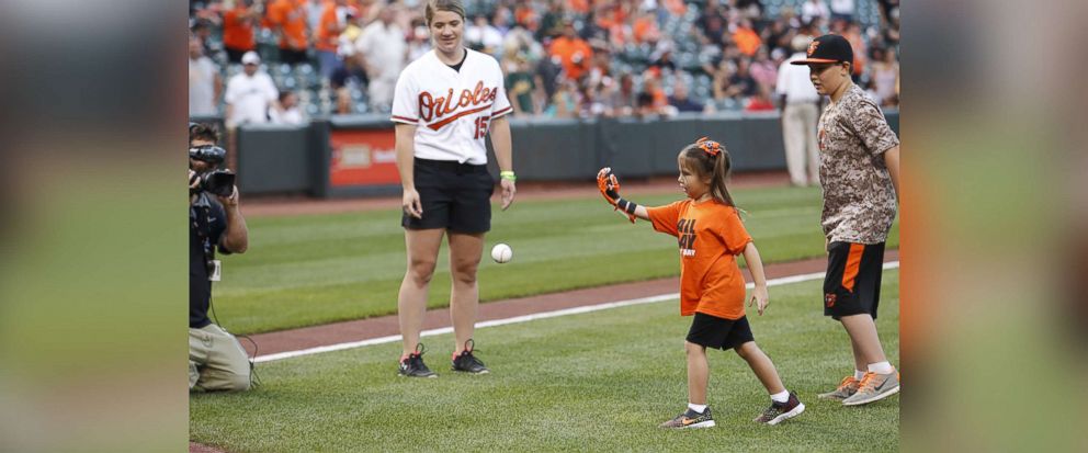 PHOTO: Hailey Dawson, a 7-year-old from Nevada, has thrown the first pitch with her 3-D printed hand for two major league baseball teams and hopes to reach her goal of 28 more. 