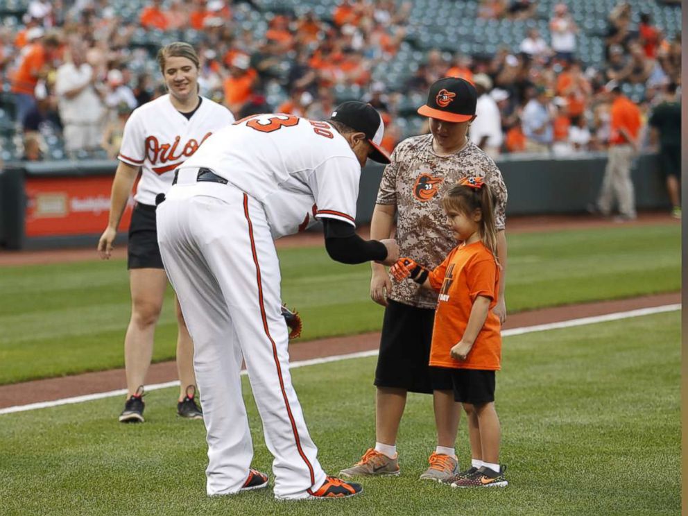 PHOTO: Hailey Dawson, a 7-year-old from Nevada, has thrown the first pitch with her 3-D printed hand for two major league baseball teams and hopes to reach her goal of 28 more.