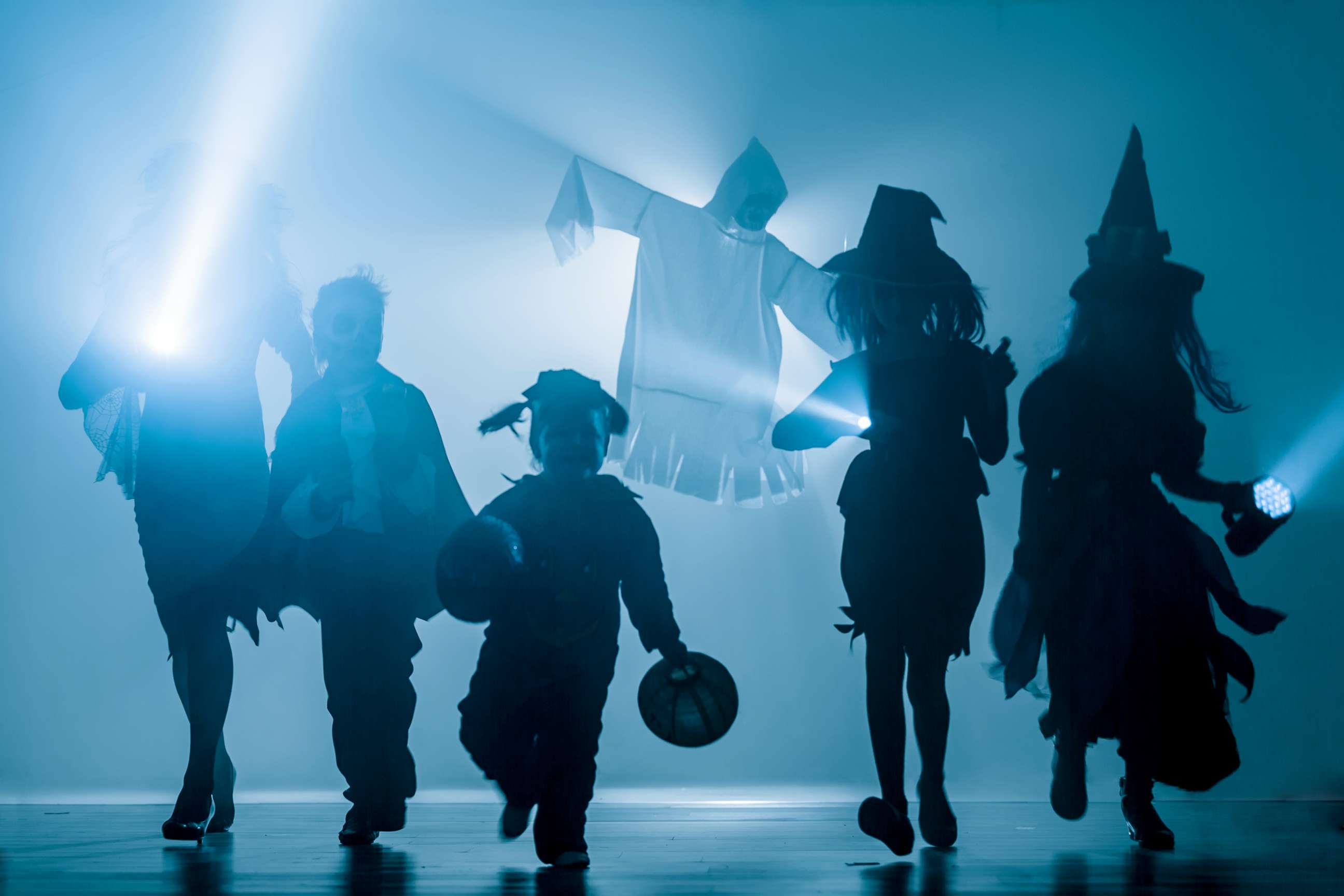 PHOTO: Silhouettes of children dressed in Halloween costumes. 