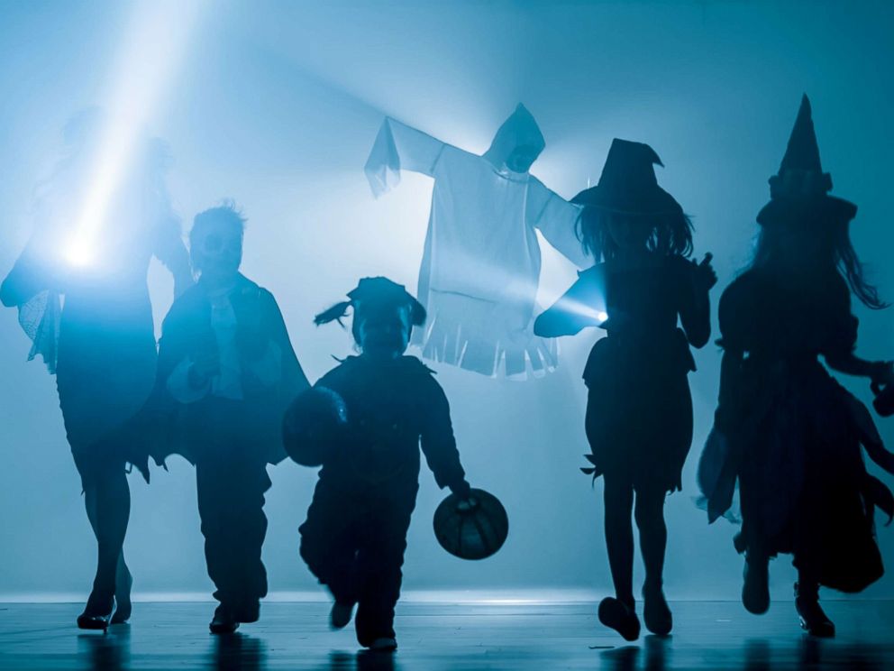 PHOTO: Silhouettes of children dressed in Halloween costumes.