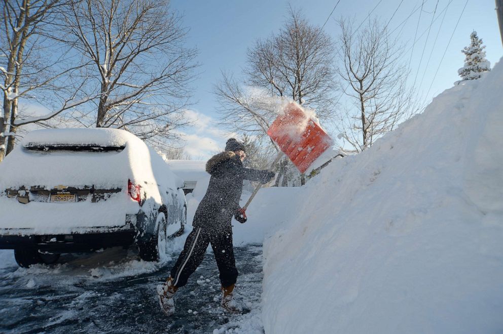 PHOTO: Heather Ahmed digs out after an intense lake-effect snowstorm impacted the area on Nov. 19, 2022, in Hamburg, N.Y.