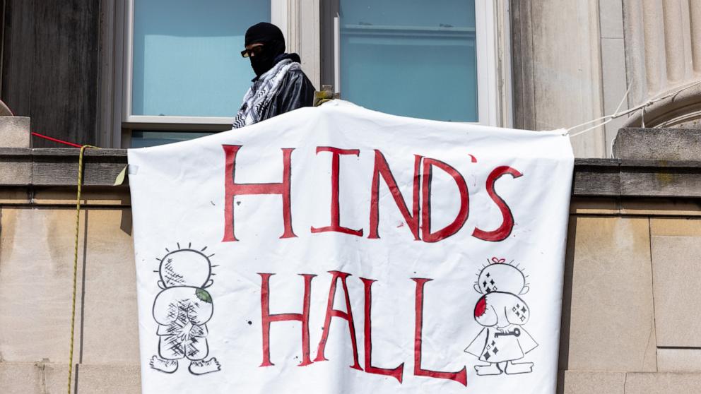 A Pro-Palestinian protestor who is occupying Hamilton Hall looks out into a crowd at Columbia University on April 30, 2024 in New York City. (Photo by Michael M. Santiago/Getty Images)