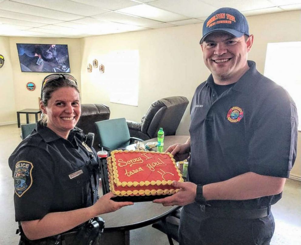 PHOTO: Hamilton Township Police Officer Darcy Workman gifted Hamilton Township firefighter Rickey Wagoner with a cake to apologize for accidentally hitting him with a stun gun. 

