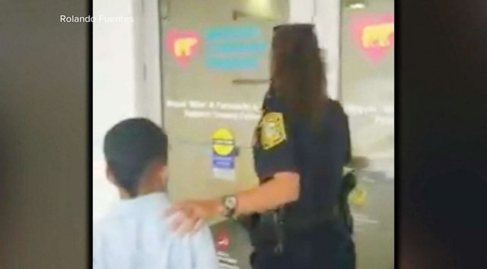 PHOTO: A 7-year-old boy emerged from a Miami-Dade police car's back seat on Jan. 26, 2018, in metal handcuffs while his mother videotaped and comforted him from just a few feet away.