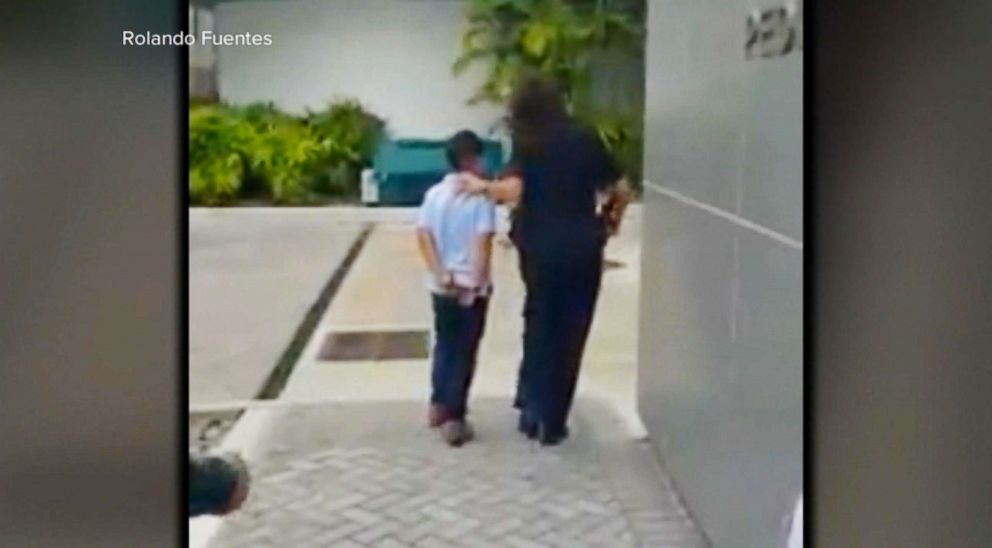 PHOTO: A 7-year-old boy emerged from a Miami-Dade police car's back seat on Jan. 26, 2018, in metal handcuffs while his mother videotaped and comforted him from just a few feet away.