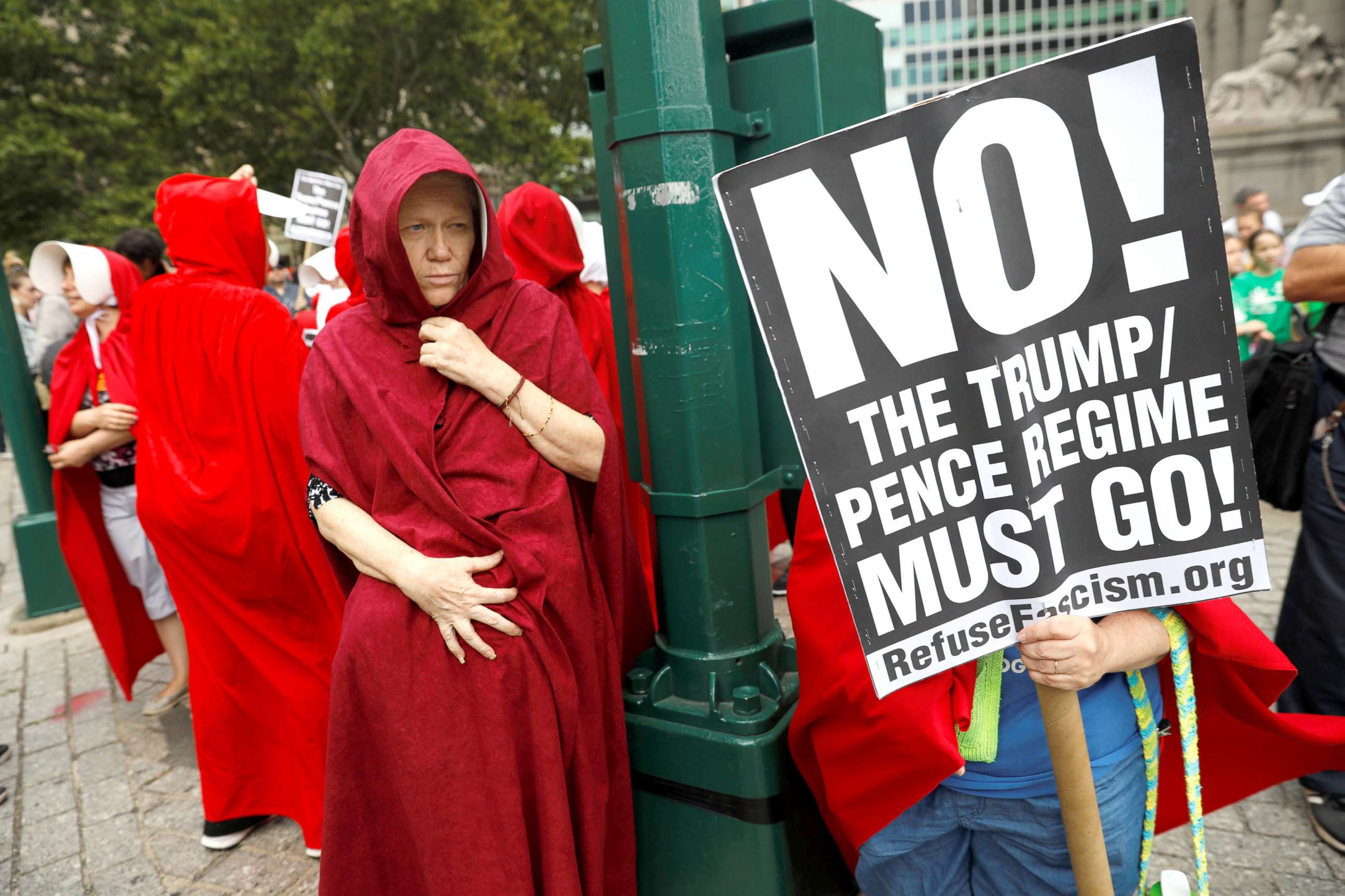 PHOTO: Women dressed in red gowns as worn in the "Handmaids Tale" protest outside the Department of Homeland Security (DHS) Cybersecurity Summit where U.S. Vice President Mike Pence, July 31, 2018, in Manhattan, New York City.