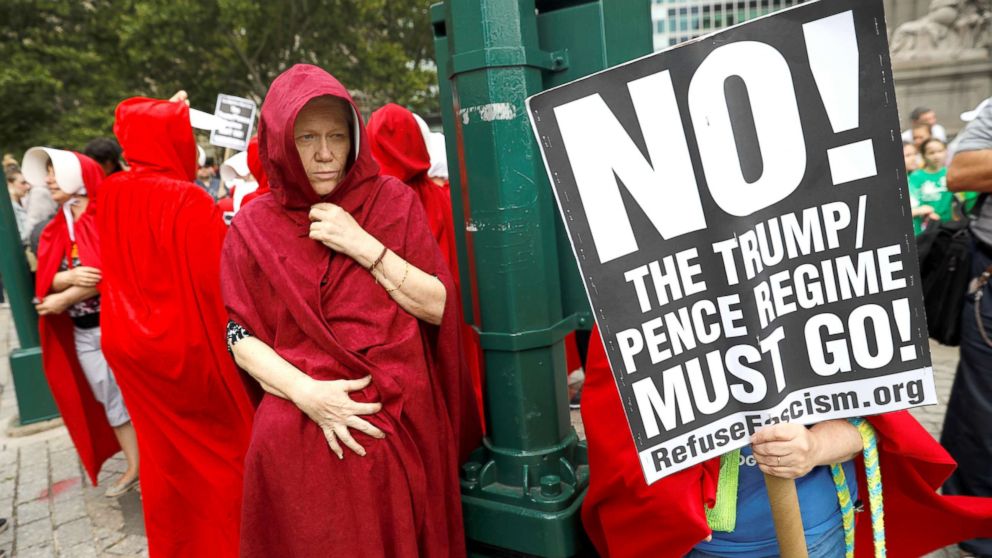 PHOTO: Women dressed in red gowns as worn in the "Handmaids Tale" protest outside the Department of Homeland Security (DHS) Cybersecurity Summit where U.S. Vice President Mike Pence, July 31, 2018, in Manhattan, New York City.