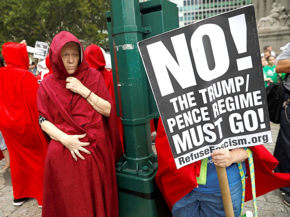 PHOTO: Women dressed in red gowns as worn in the Handmaids Tale protest outside the Department of Homeland Security (DHS) Cybersecurity Summit where U.S. Vice President Mike Pence, July 31, 2018, in Manhattan, New York City.