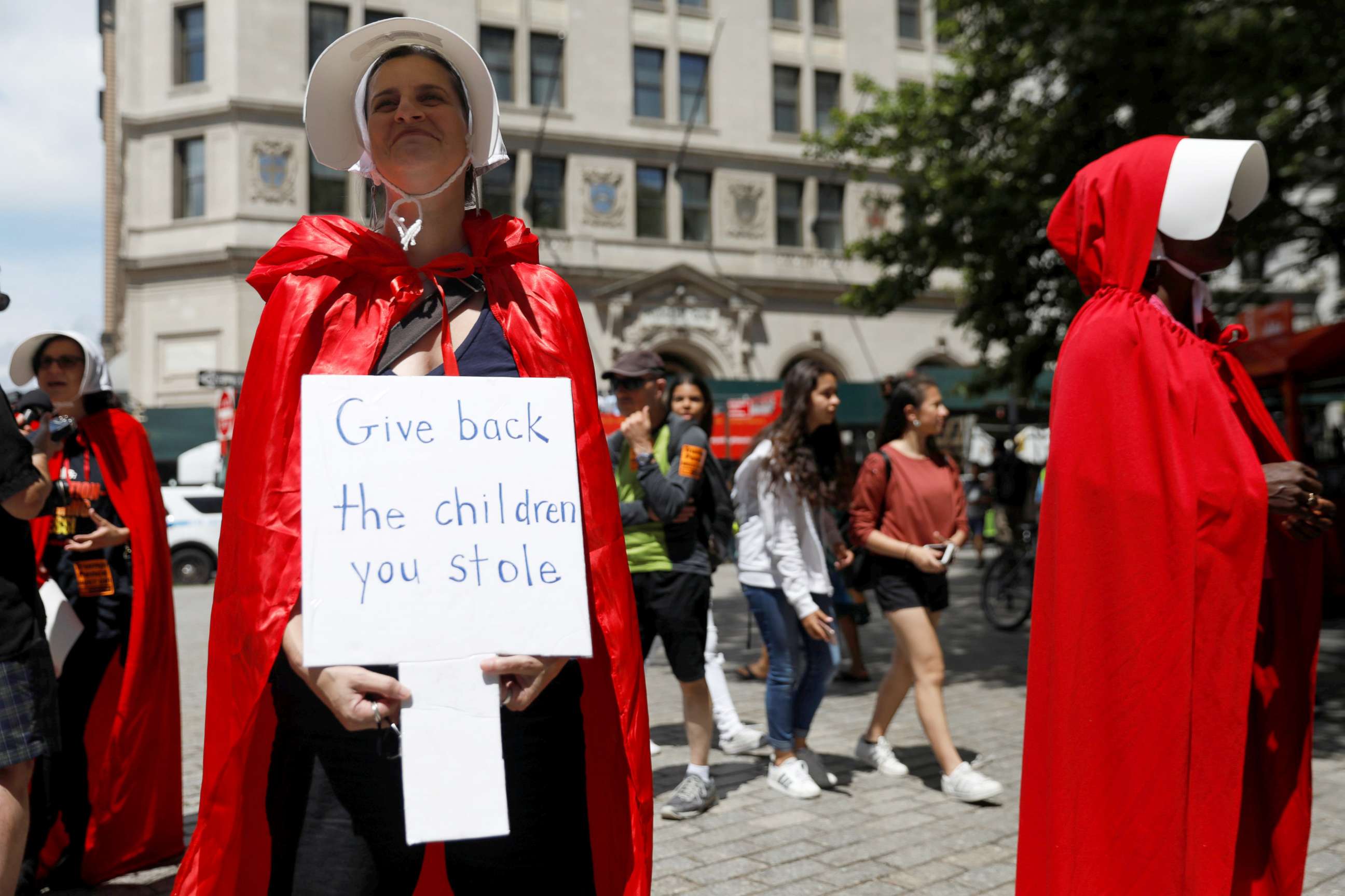 PHOTO: Women dressed in red gowns as worn in the "Handmaids Tale" protest U.S. Vice President Mike Pence and Department of Homeland Security (DHS) Secretary Kirstjen Nielsen outside the DHS Cybersecurity Summit in New York City, July 31, 2018.