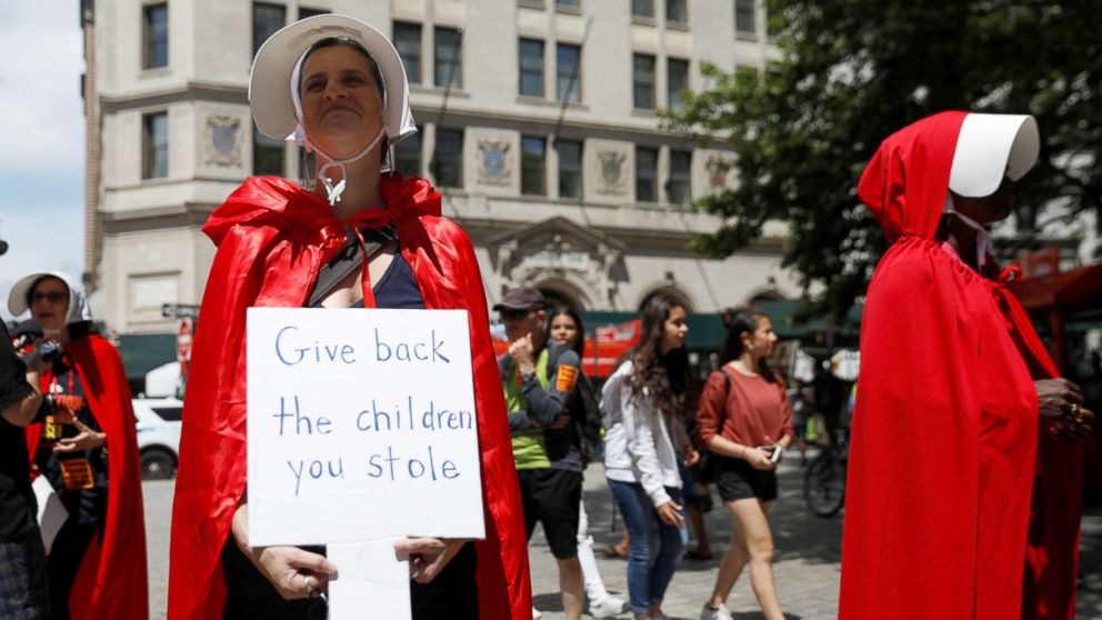 PHOTO: Women dressed in red gowns as worn in the "Handmaids Tale" protest U.S. Vice President Mike Pence and Department of Homeland Security (DHS) Secretary Kirstjen Nielsen outside the DHS Cybersecurity Summit in New York City, July 31, 2018.