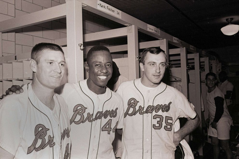 PHOTO: Hank Aaron, center, with fellow Milwaukee Braves teammates, Bill O'Dell, left and pitcher Phil Niekro, right, after a win against the San Francisco Giants, in Milwaukee, Wis., Sept. 17, 1965.