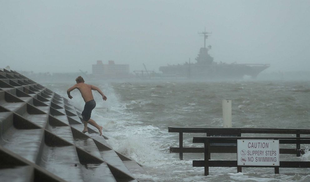 PHOTO: A man jumps from a wave as Hurricane Hanna begins to make landfall, Saturday, July 25, 2020, in Corpus Christi, Texas.