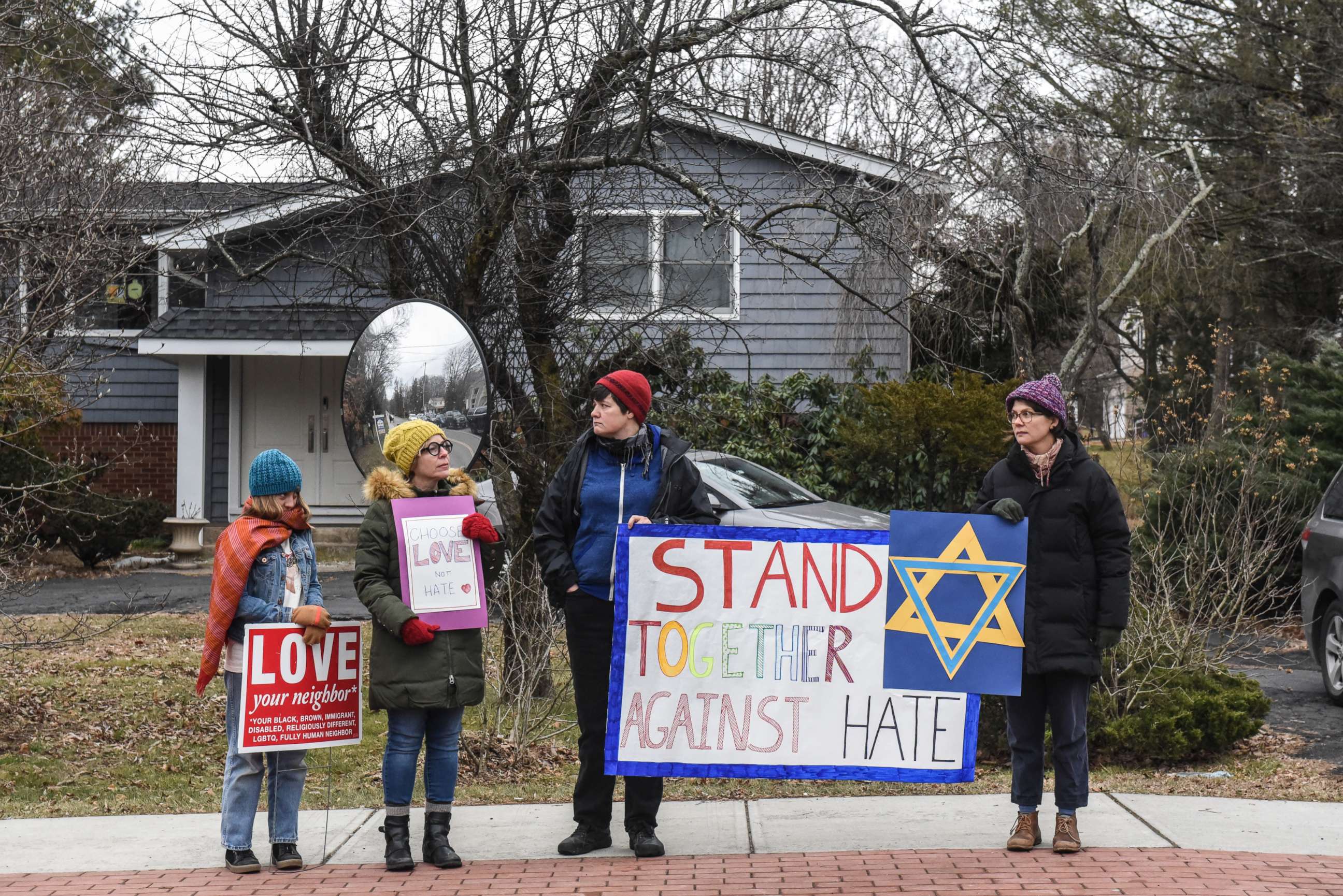 PHOTO: People hold signs of support near the house of Rabbi Chaim Rottenberg on Dec. 29, 2019, in Monsey, N.Y. Five people were injured in a knife attack during a Hanukkah party and a suspect, identified as Grafton E. Thomas, was later arrested in Harlem.