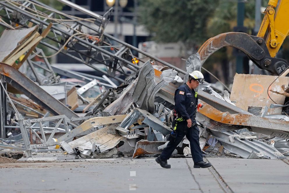 PHOTO: A worker walks in front of rubble in the street at the site of the Hard Rock Hotel in New Orleans, Oct. 16, 2019.