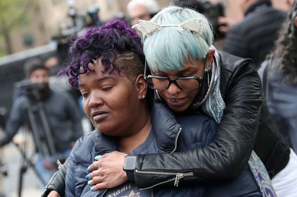 PHOTO: Women embrace outside an apartment building in the Harlem neighbourhood of Manhattan where several people died in a fire early Wednesday, in New York, May 8, 2019.