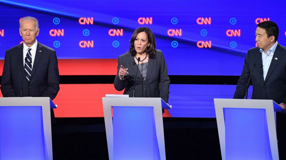 PHOTO: Kamala Harris delivers her closing statement flanked by Joe Biden and Andrew Yang during the second round of the second Democratic primary debate in Detroit, Michigan on July 31, 2019.