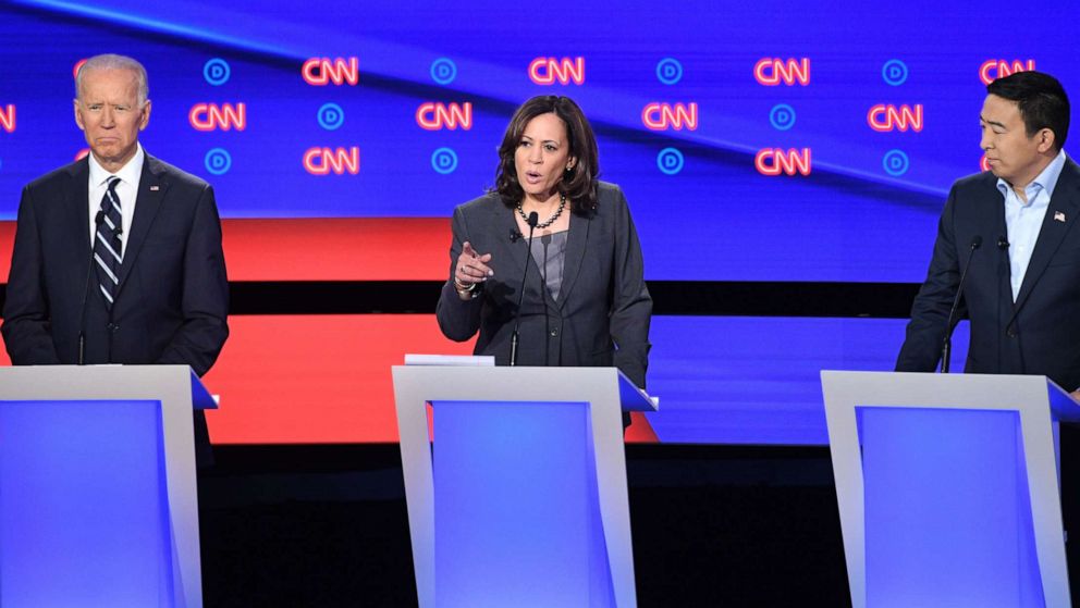 PHOTO: Kamala Harris delivers her closing statement flanked by Joe Biden and Andrew Yang during the second round of the second Democratic primary debate in Detroit, Michigan on July 31, 2019.