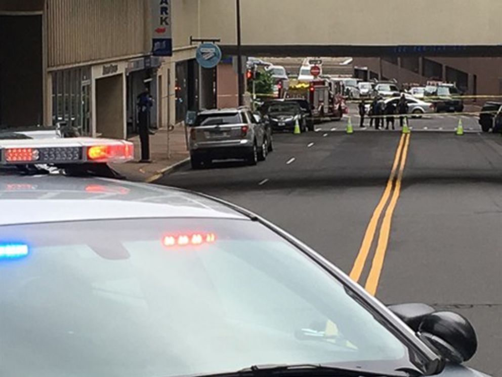 PHOTO: Police investigate the scene after a police officer was stabbed in the neck in Hartford, Conn., May 17, 2018.