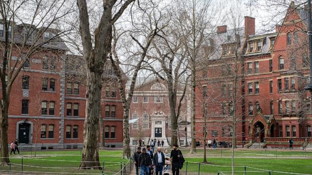 People walk through Harvard Yard on the Harvard University campus in Cambridge, Massachussetts, April 15, 2025. 
