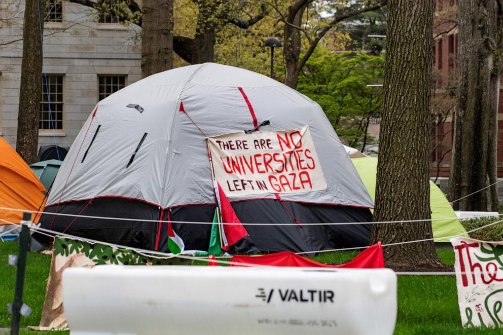 PHOTO: Tents and signs fill Harvard Yard by the John Harvard statue in the pro-Palestinian encampment at Harvard University in Cambridge, Mass., on May 5, 2024.
