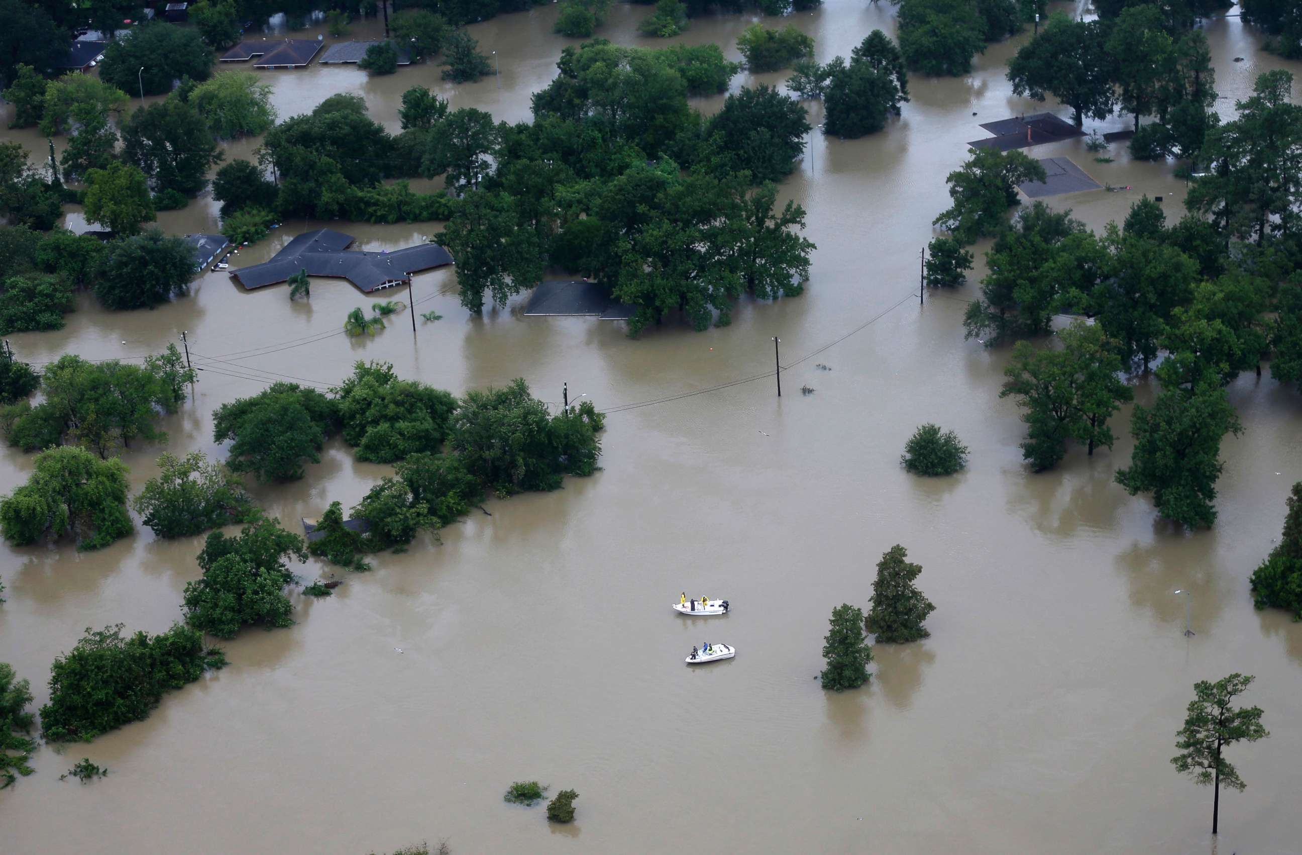 PHOTO: Boaters pass through a neighborhood that has been covered by floodwaters from Tropical Storm Harvey,  Aug. 29, 2017, in Houston.