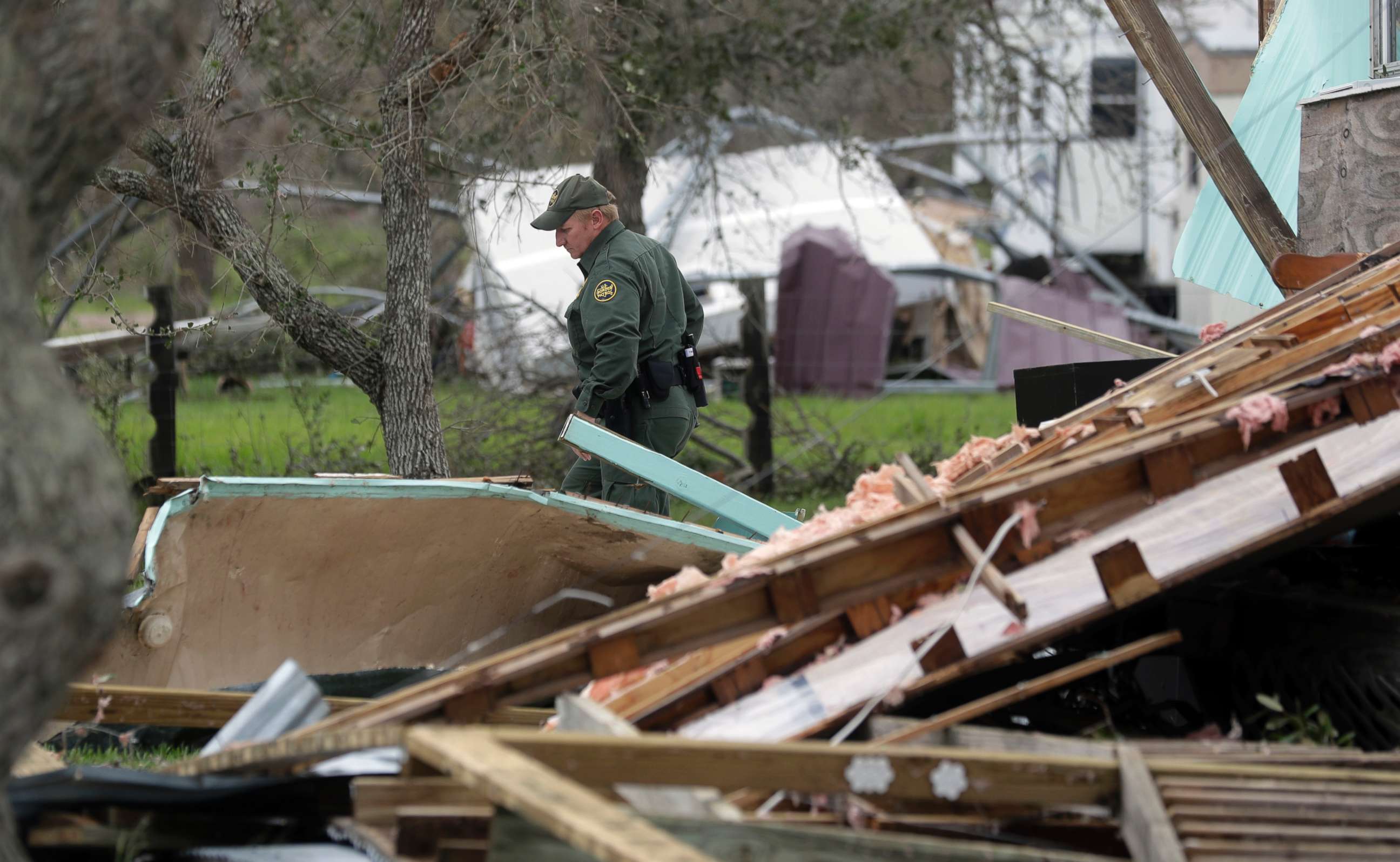 PHOTO: An official looks through debris as he checks a home damaged by Hurricane Harvey, Sunday, Aug. 27, 2017, in Rockport, Texas.