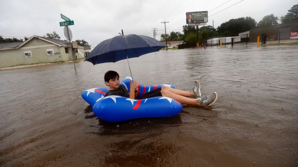 PHOTO: Julius Verret, 14, floats in street flooding in Lake Charles, La., as the city receives heavy rains from Tropical Storm Harvey, on Aug. 27, 2017. 