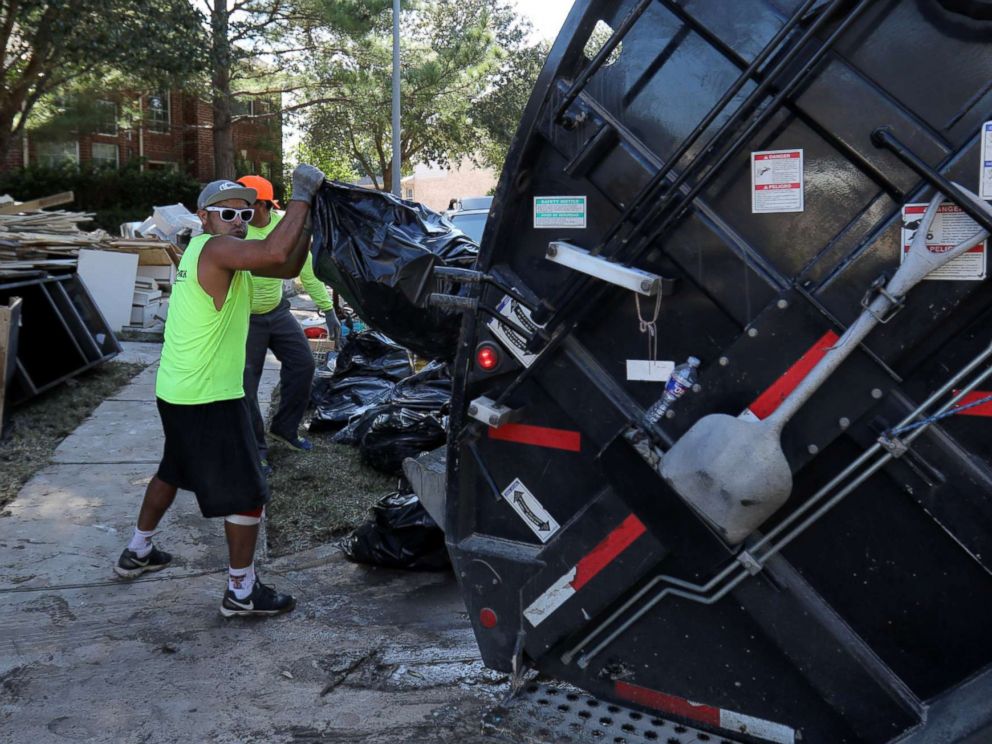 PHOTO: A garbage truck helps residents remove bags of flood-damaged items that line the streets of numerous neighborhoods in the aftermath of tropical storm Harvey on the west side of Houston, Texas, U.S., Sept. 7, 2017.