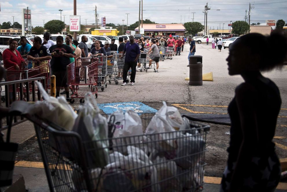 PHOTO: People wait in line to buy groceries at a Food Town during the aftermath of Hurricane Harvey on Aug. 30, 2017 in Houston, Texas.