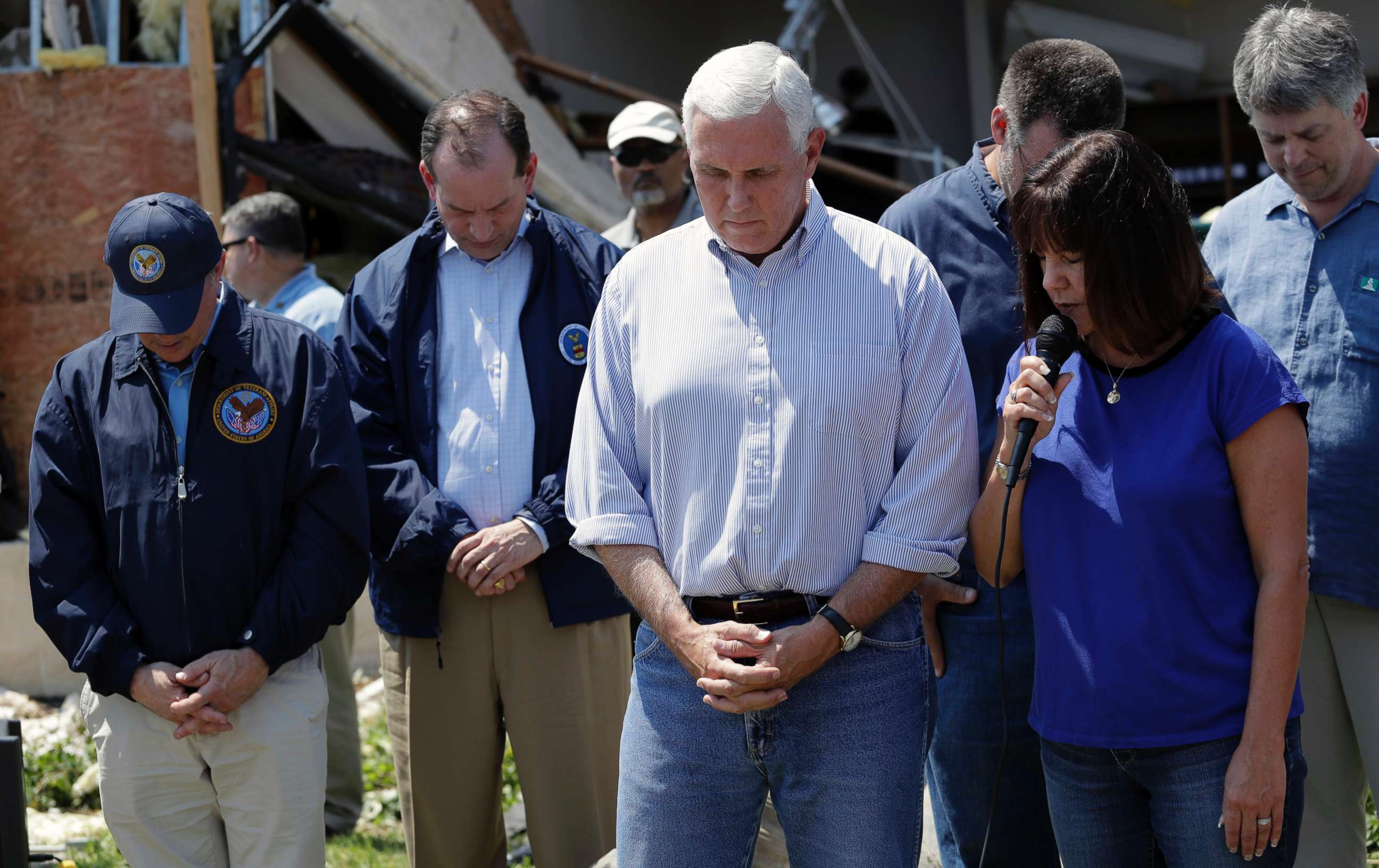 PHOTO: Vice President Mike Pence, center, and others bow their heads as his wife, Karen says a prayer during the couple's visit to the First Baptist Church of Rockport, Aug. 31, 2017, in Rockport, Texas.