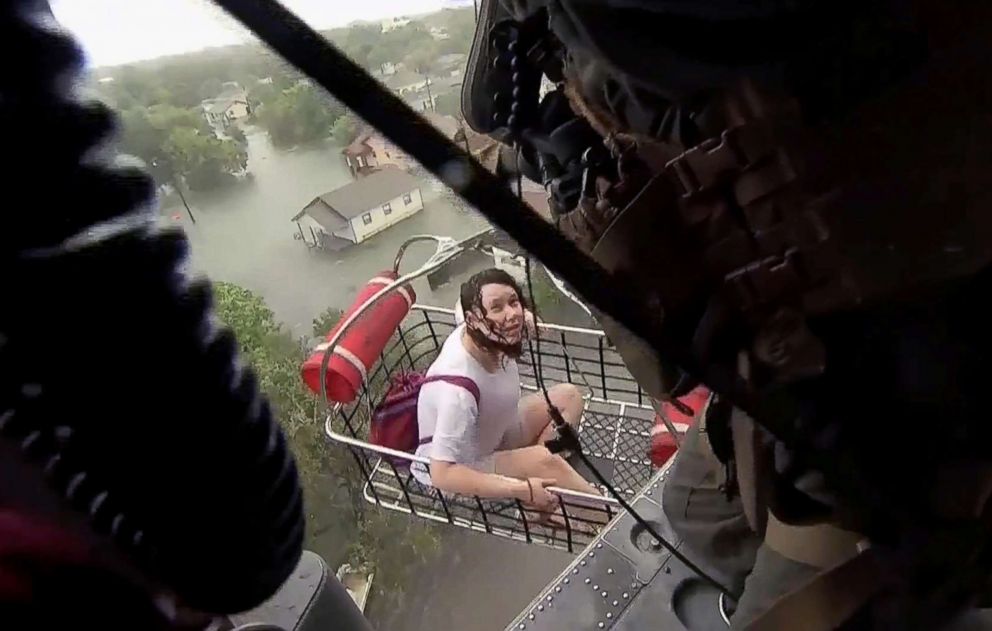 PHOTO: A woman is rescued from flood waters by a U.S. Navy Helicopter Sea Combat Squadron 7 crew in Beaumont, Texas, Aug. 30, 2017. 